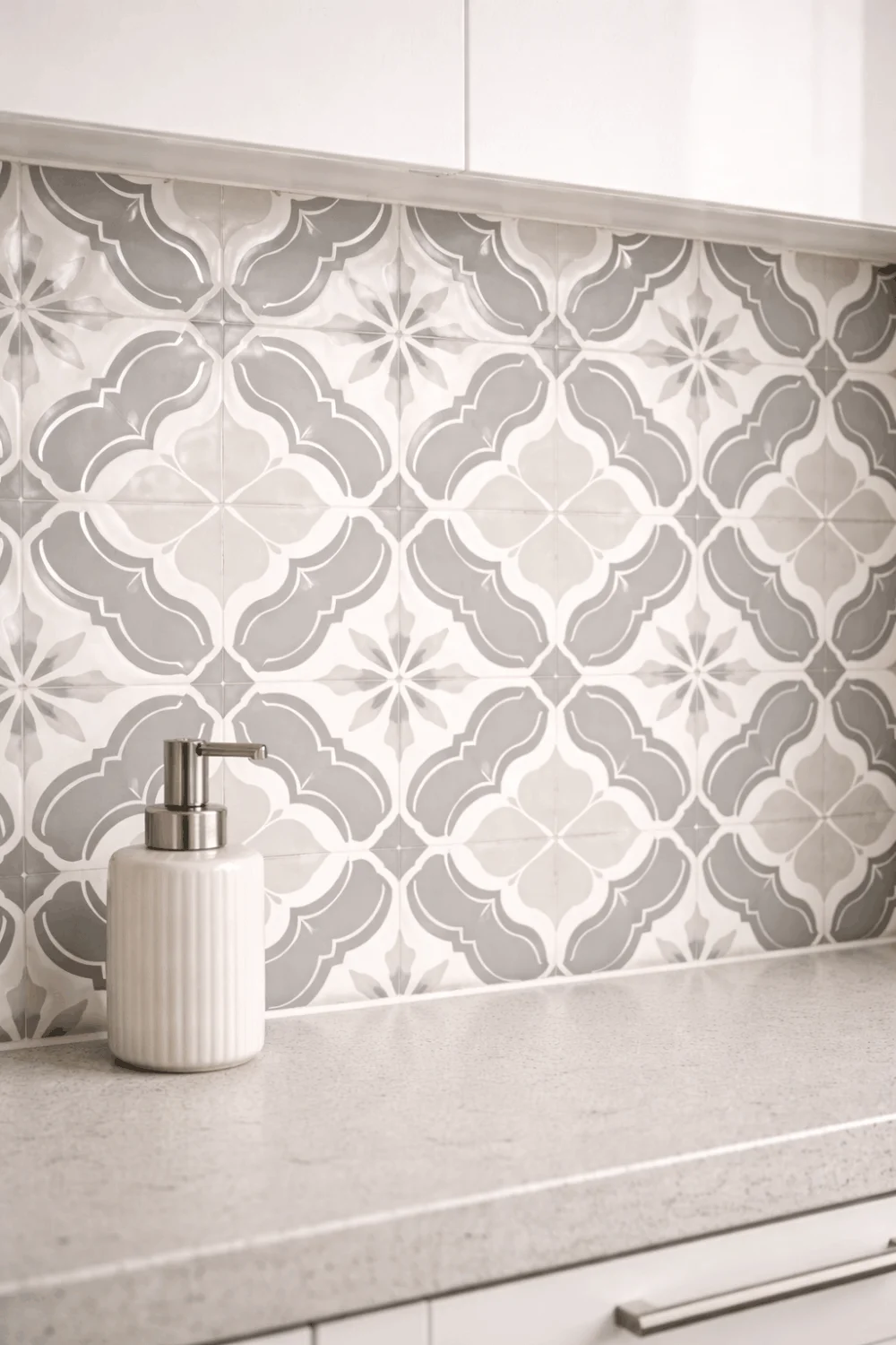 Modern geometric peel-and-stick tile backsplash in a small kitchen, demonstrating a stylish renter-friendly decor upgrade.